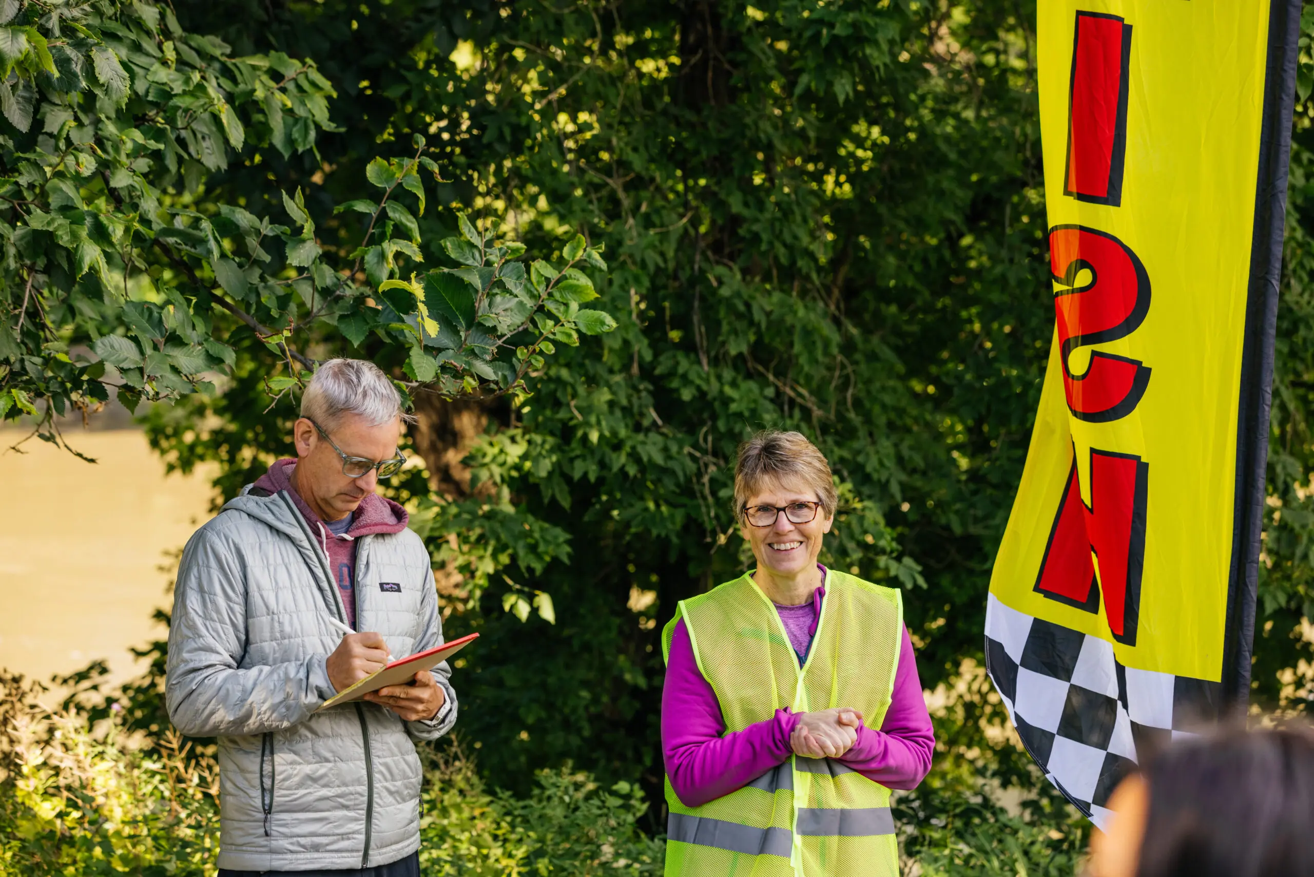 Man and woman facilitating a pride fun run event