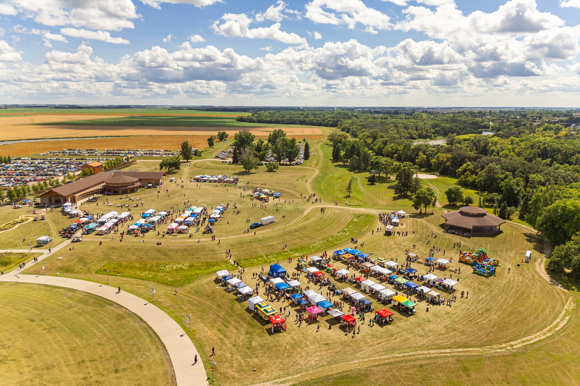Aerial view of a vibrant pride event, showcasing colorful flags, diverse attendees, and festive decorations