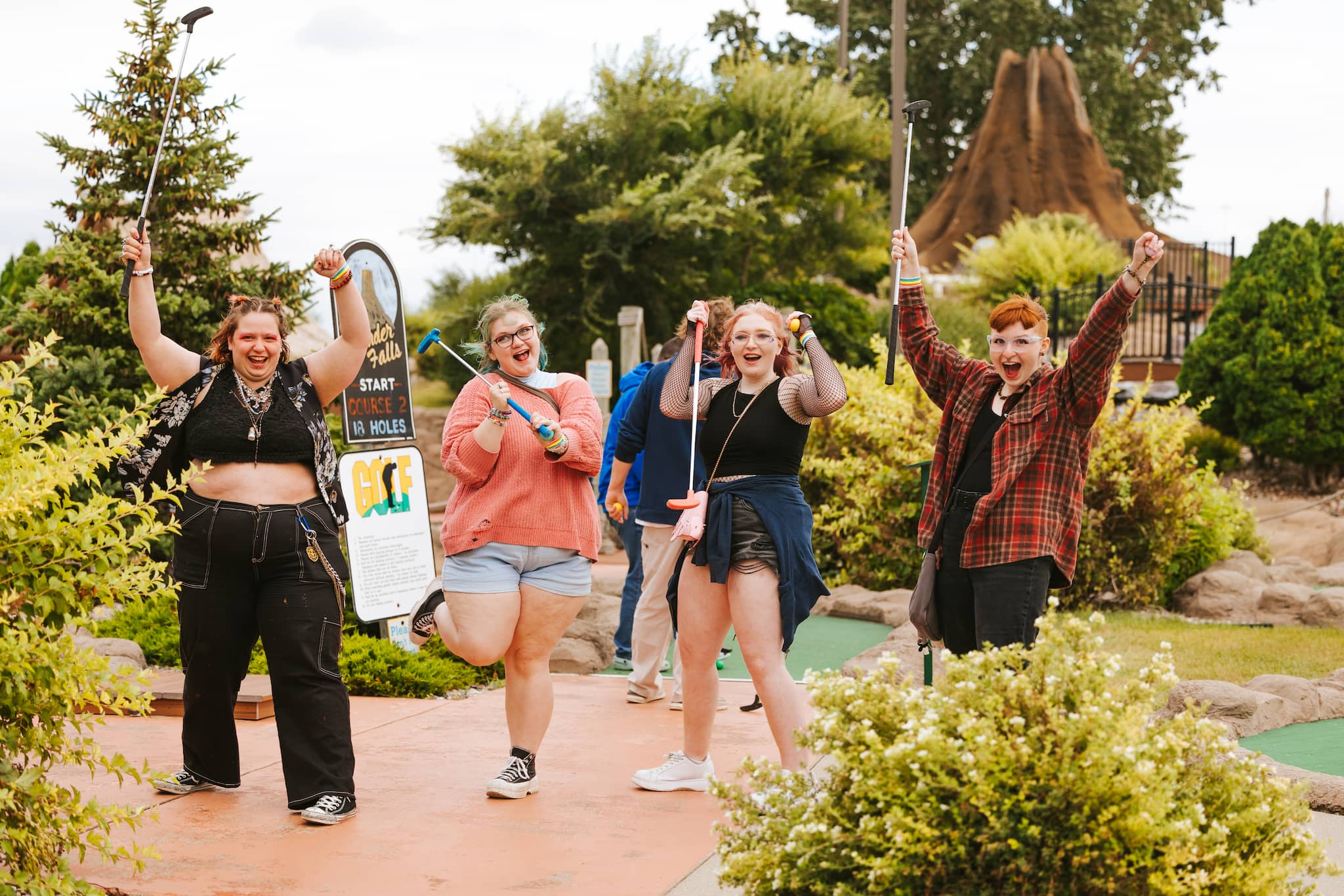 Pride members on a mini golf course, showcasing pride community spirit